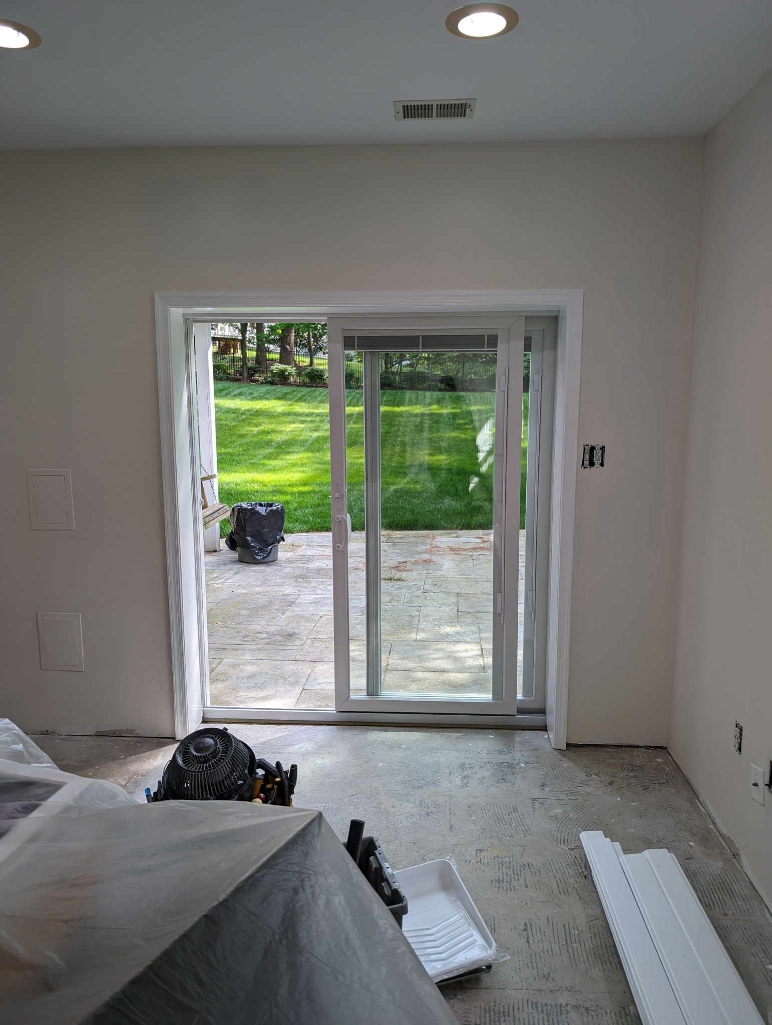 A room with a sliding glass door leading to a patio.