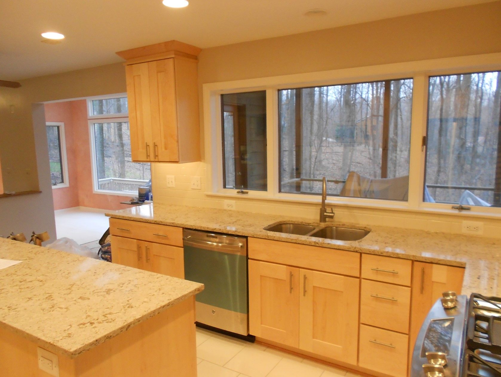 A kitchen with wooden cabinets and granite counter tops