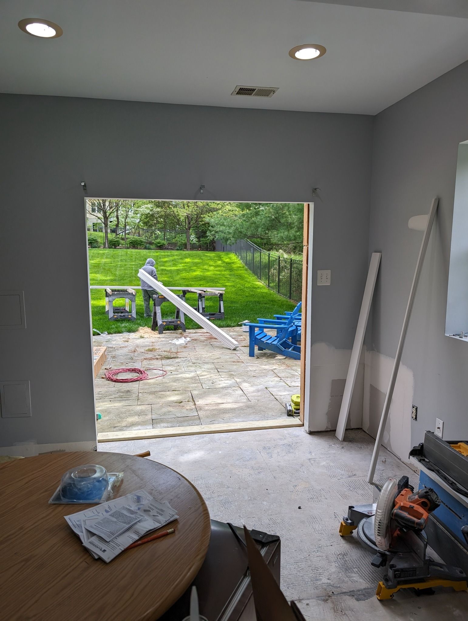 A room with a table and a sliding glass door leading to a patio.