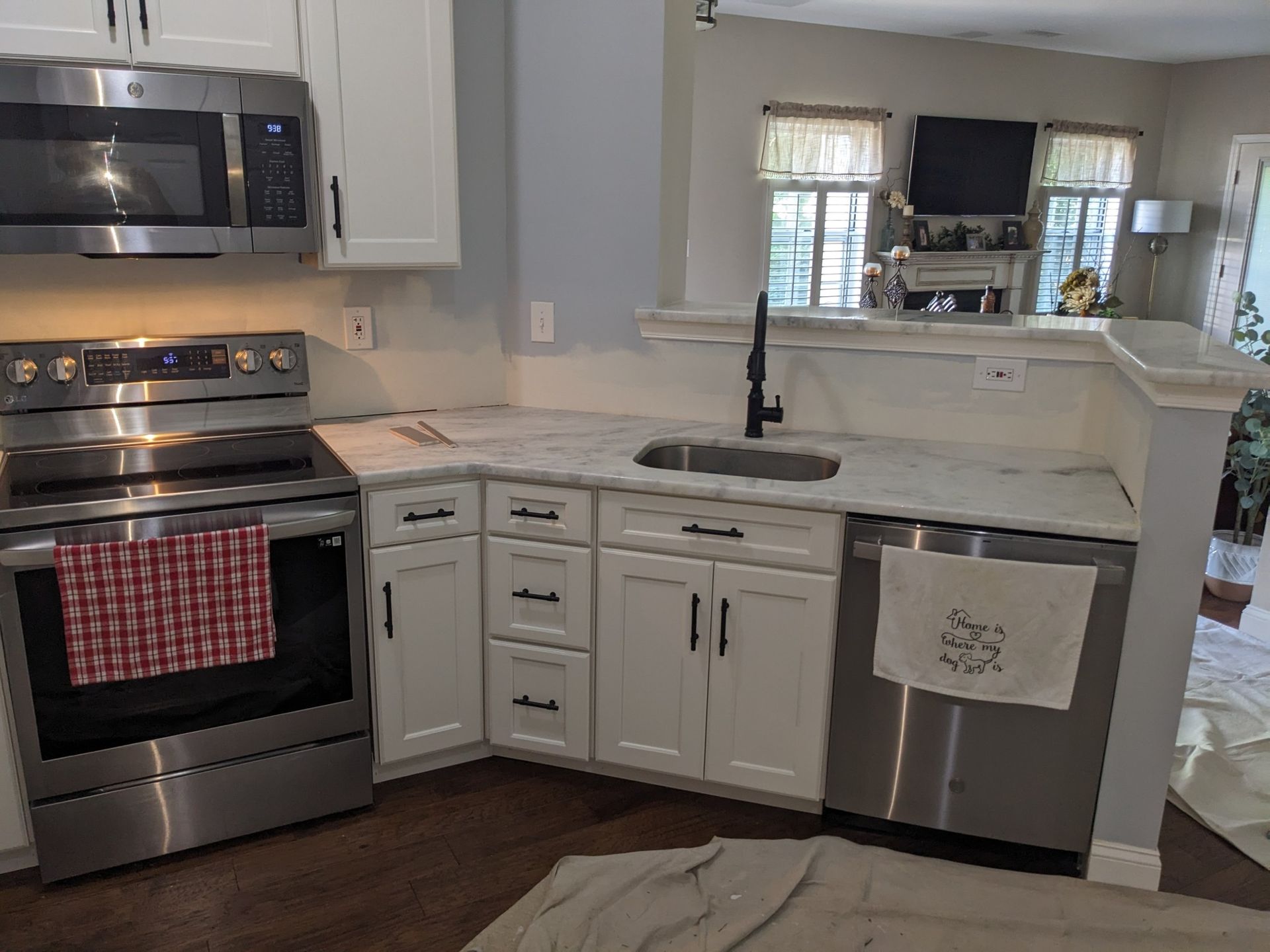 A kitchen with stainless steel appliances and white cabinets