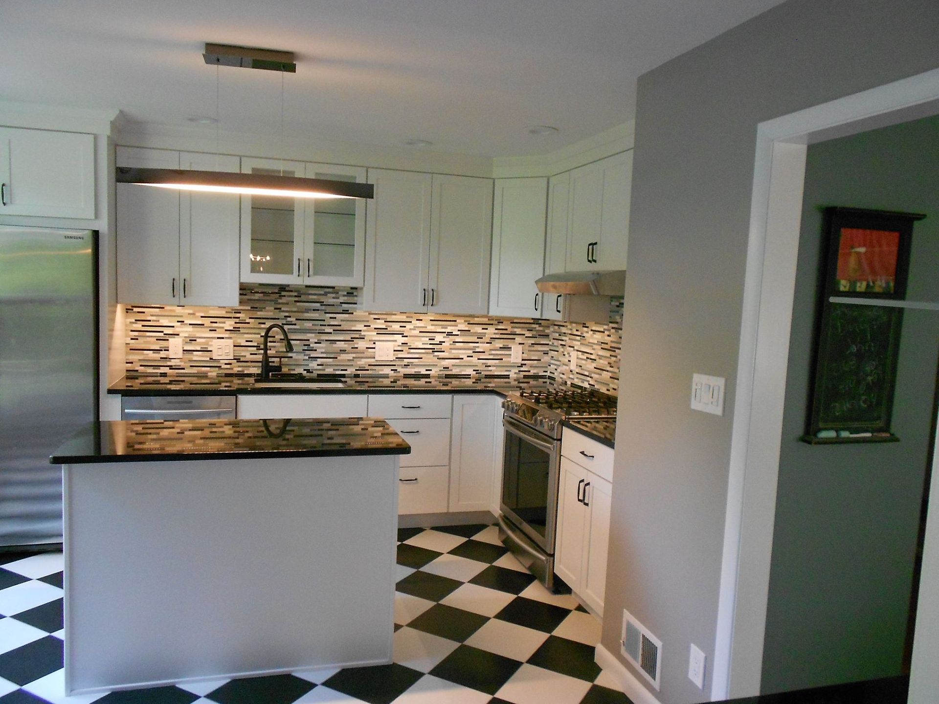 A kitchen with a black and white checkered floor