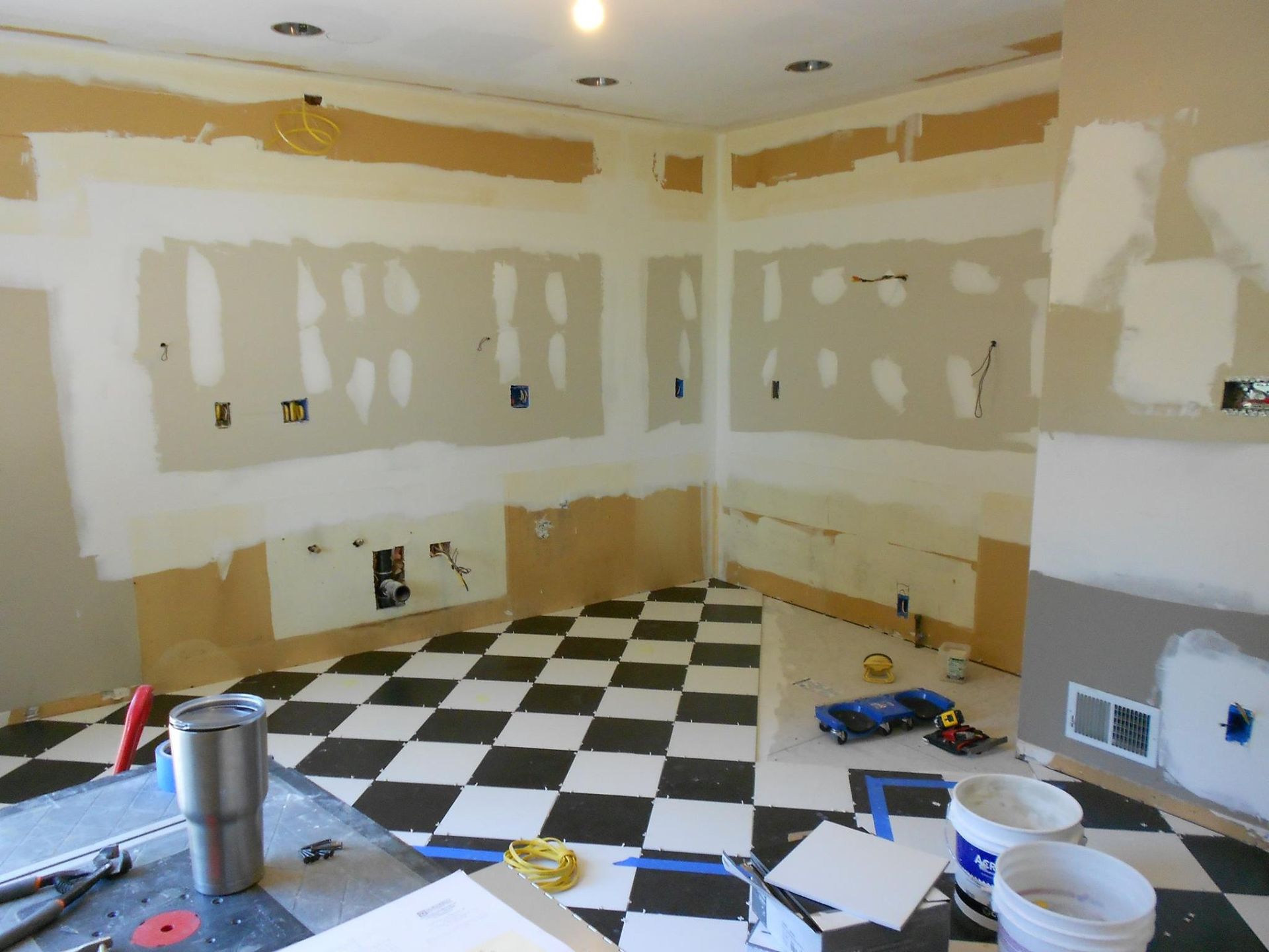 A room that is being remodeled with a checkered floor