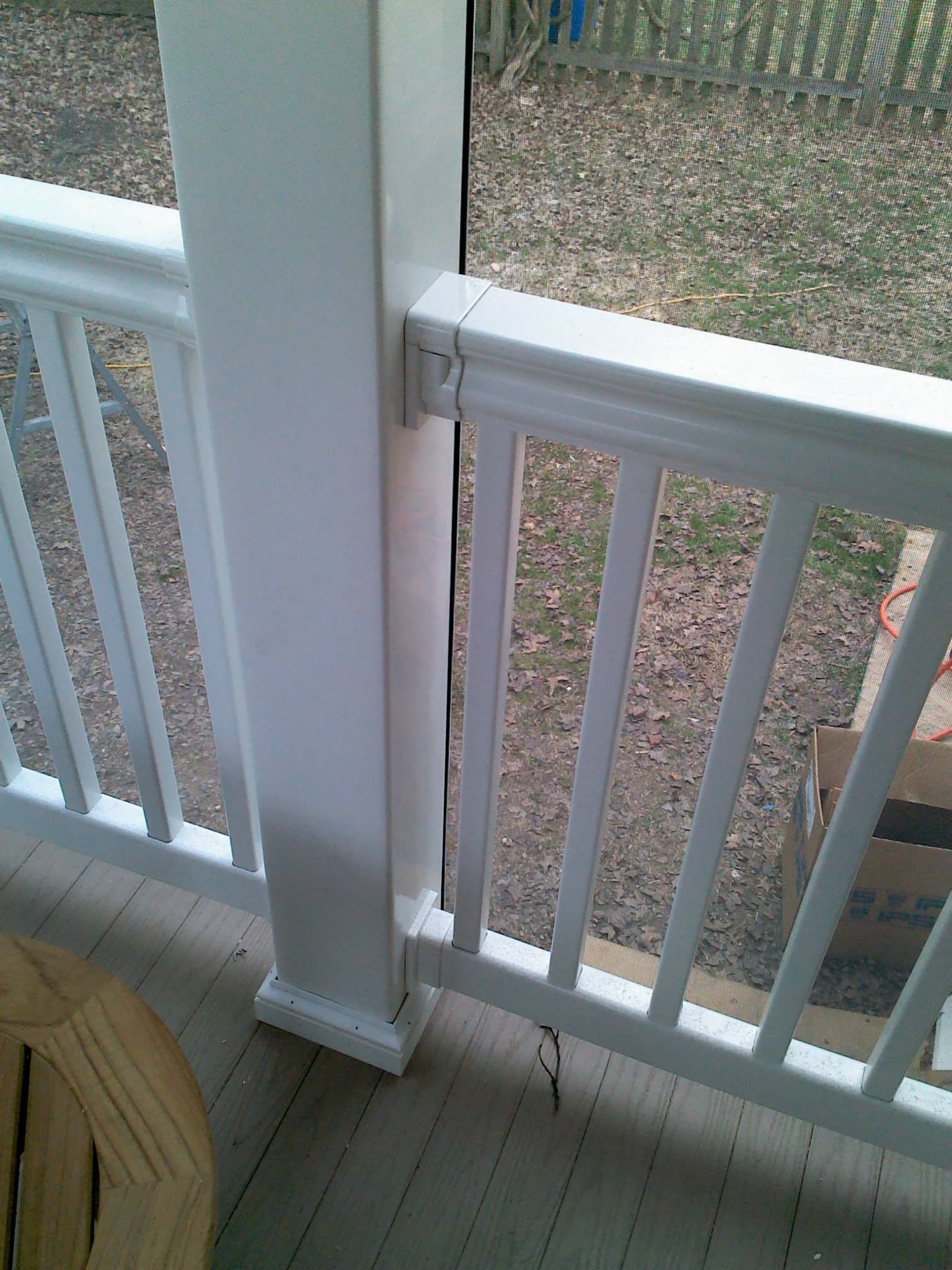 A close up of a white railing on a porch