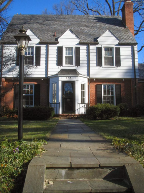 A house with a walkway leading to the front door