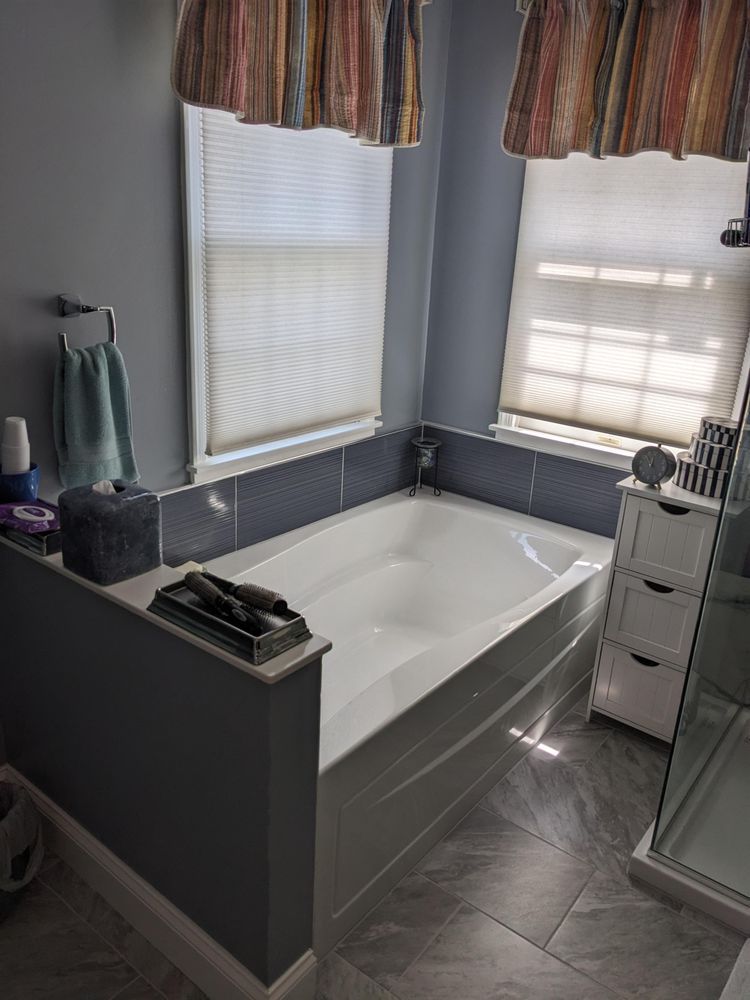There is a bathtub in the middle of the bathroom.