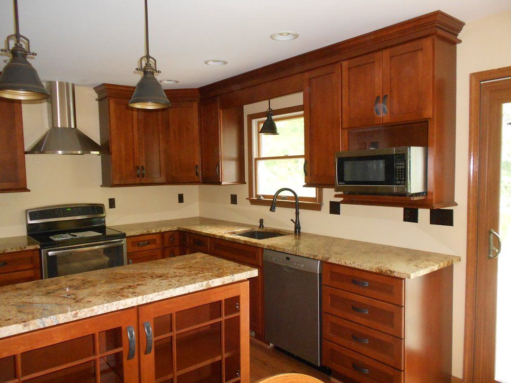 A kitchen with wooden cabinets and granite counter tops