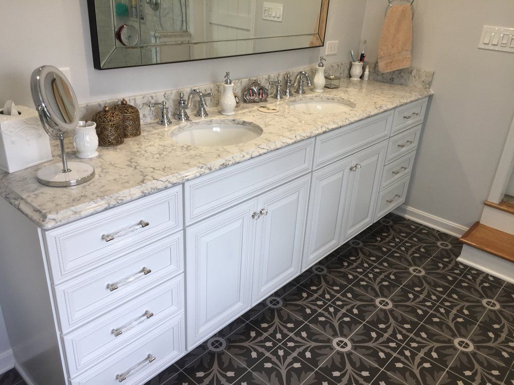 A bathroom with two sinks and a mirror.
