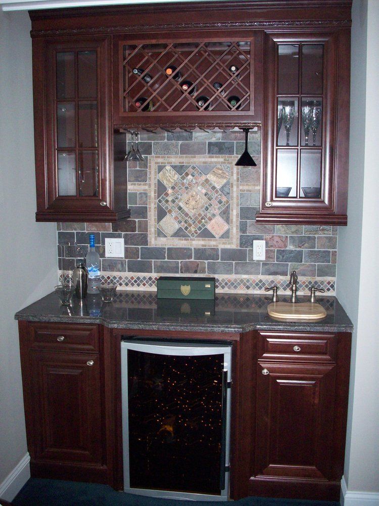 A kitchen with wooden cabinets and a wine cooler