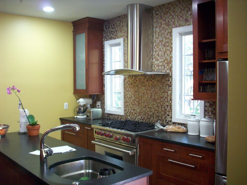 A kitchen with a stove top oven and a sink