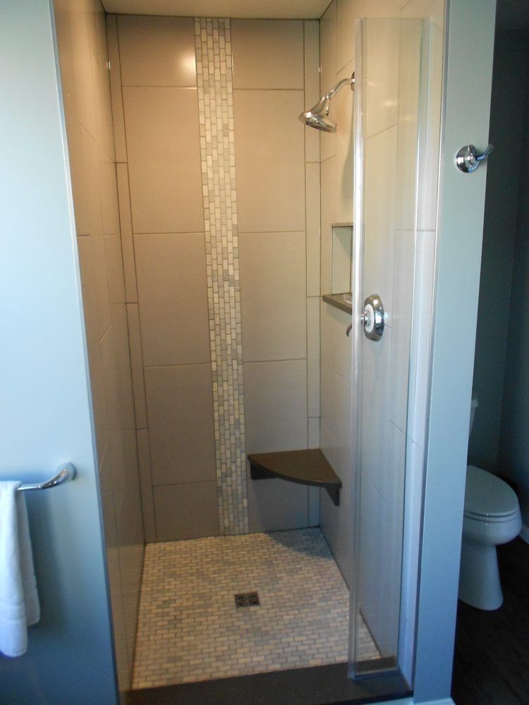 A bathroom with a walk in shower and a toilet.