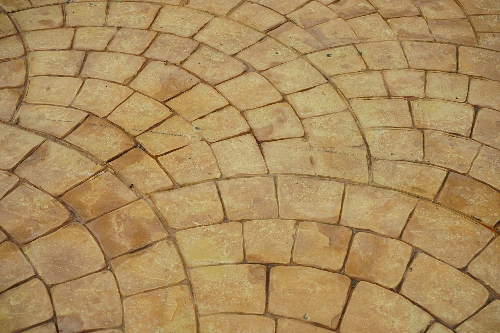 A close up of a brick floor with a circular pattern