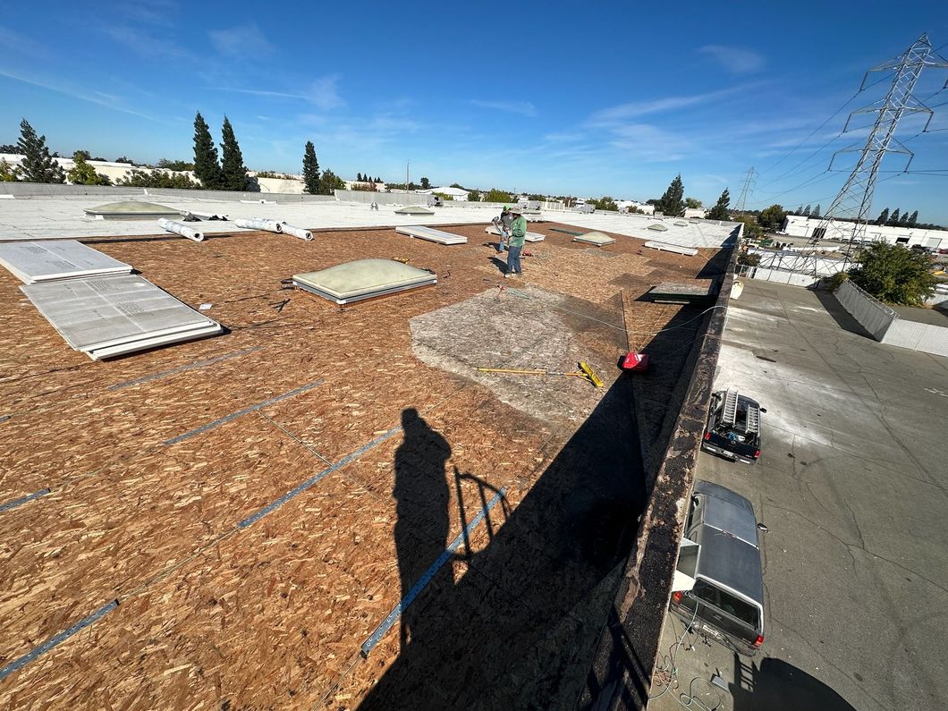 A man is standing on the roof of a building.