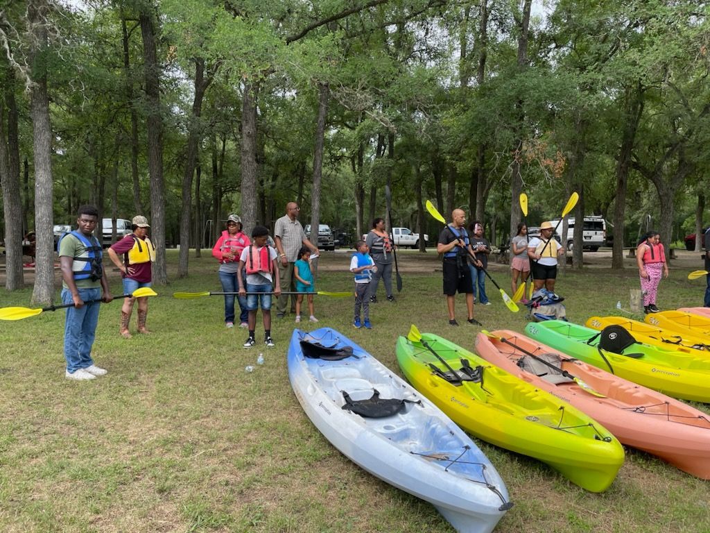 a group of people are posing for a picture in a kitchen .