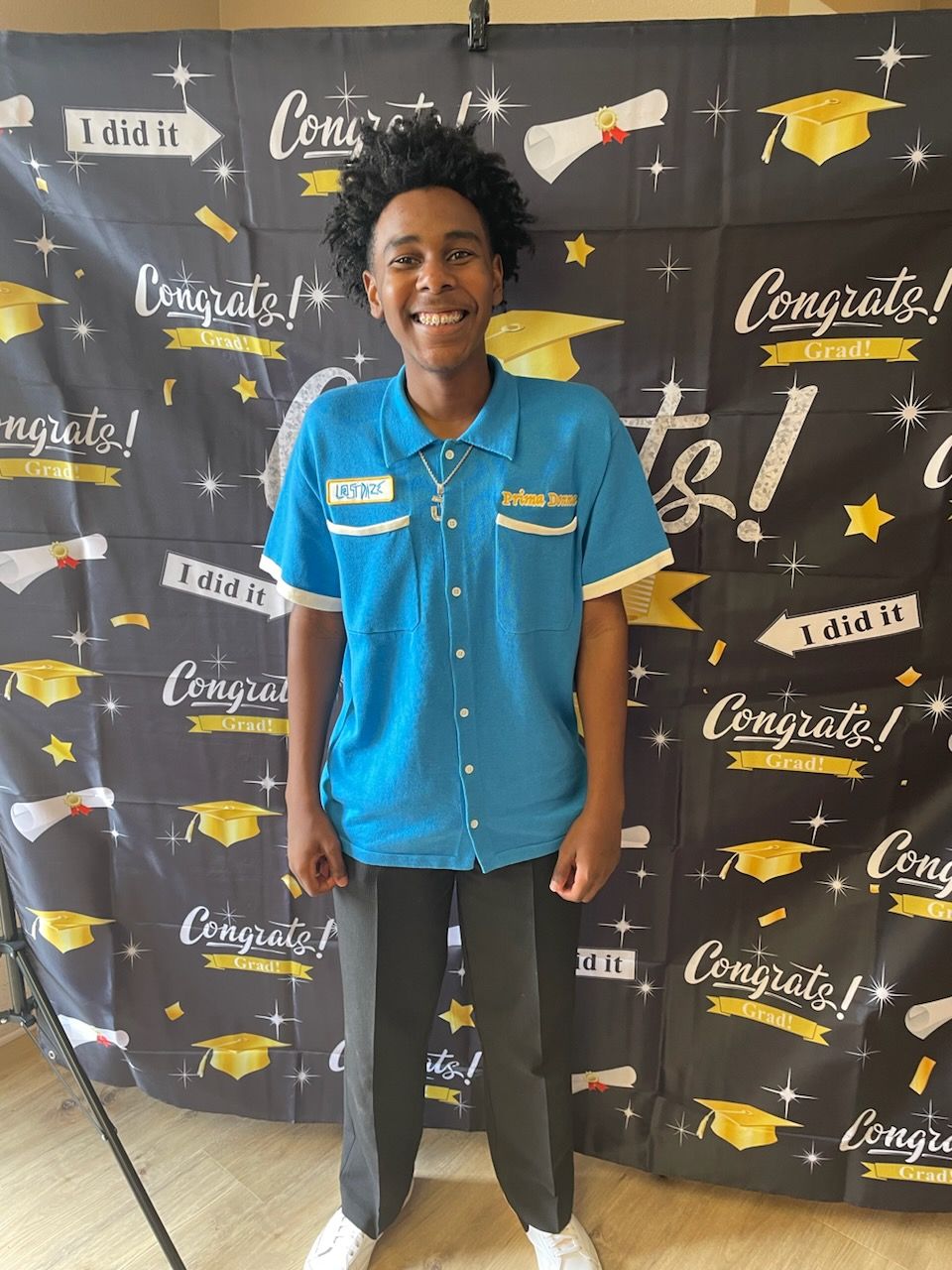 a group of people are posing for a picture in a kitchen .