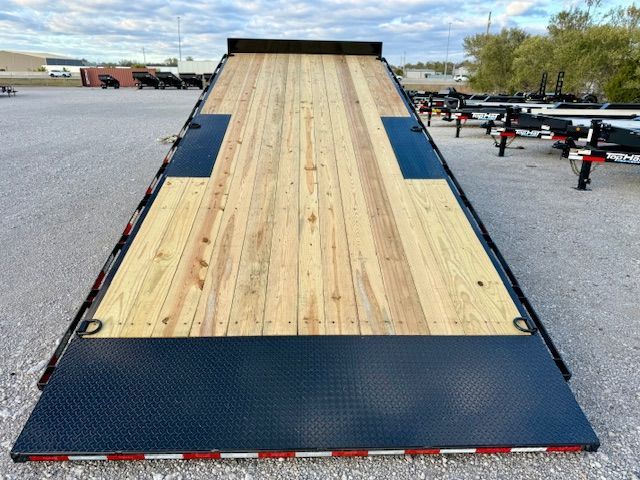 A trailer with a solar panel attached to it is parked in a field.