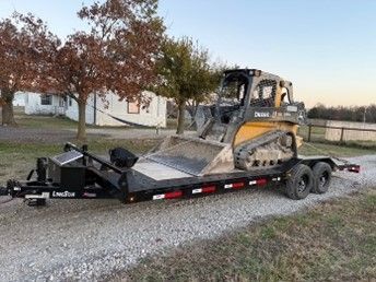 A bulldozer is sitting on top of a trailer.