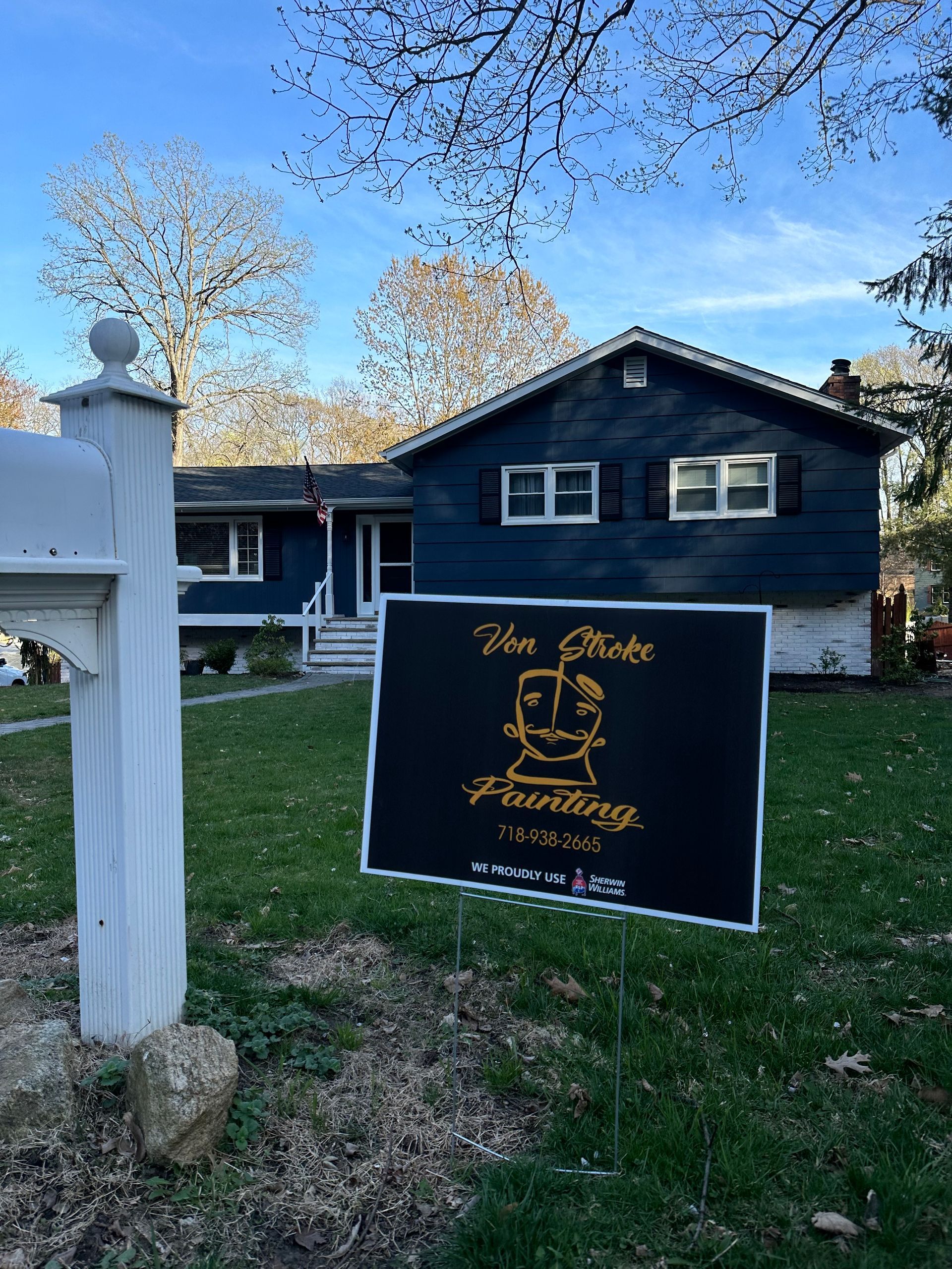 A house with a for sale sign in front of it.