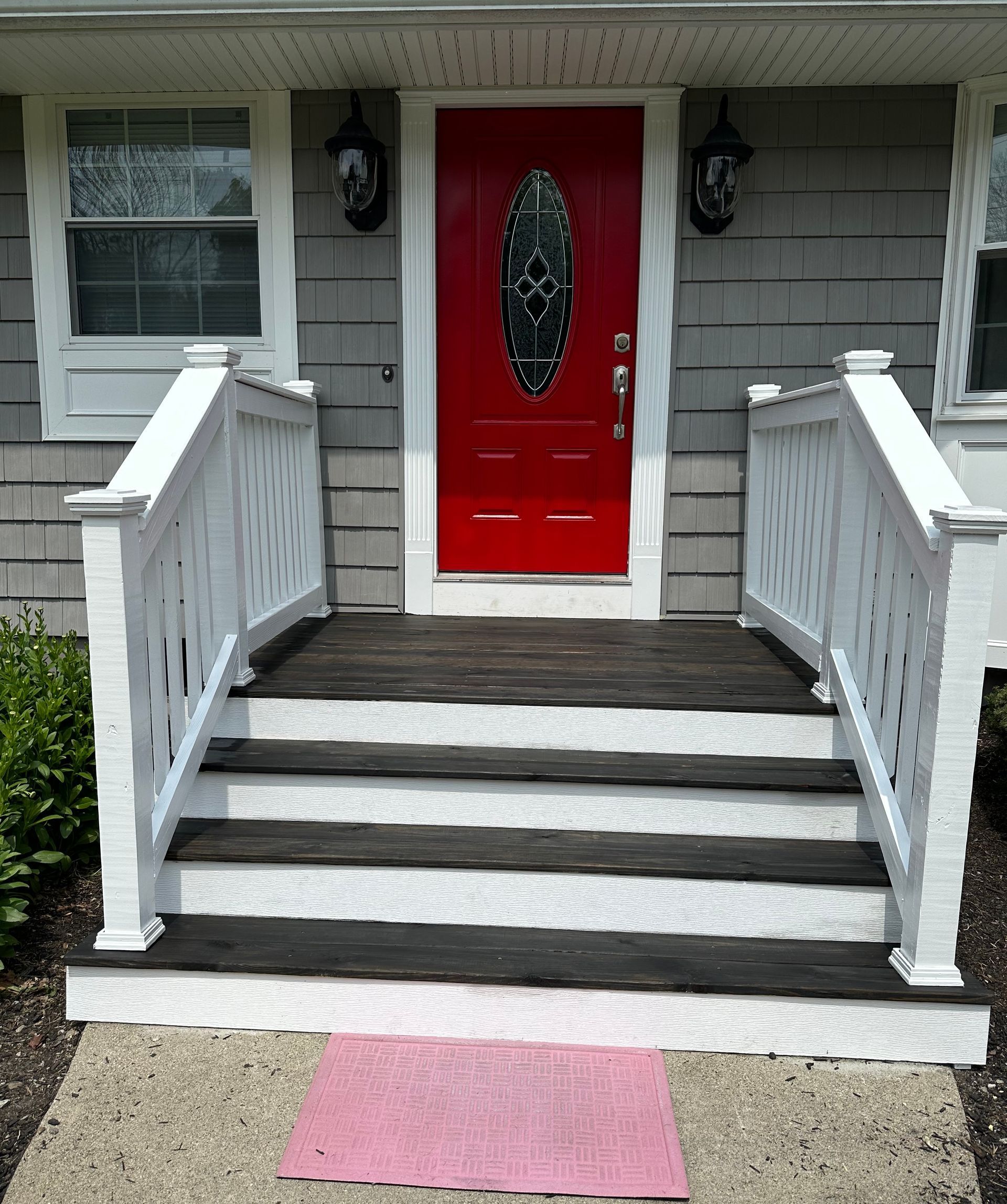 A house with a red door and white stairs
