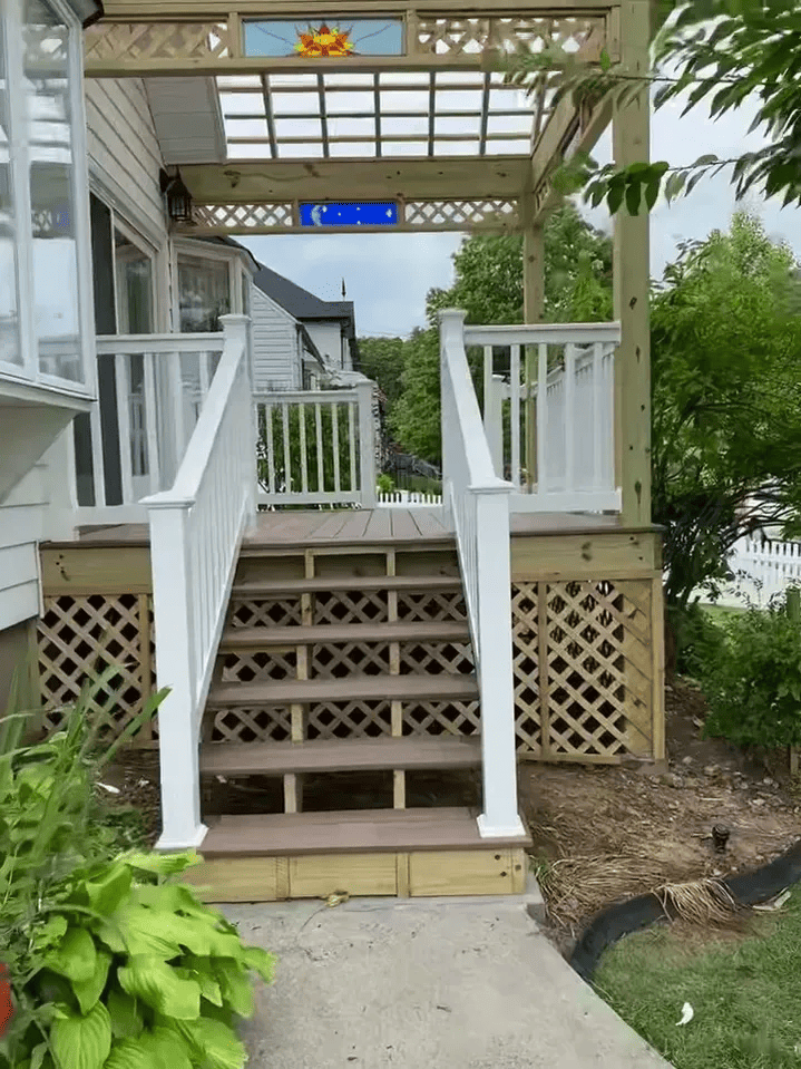 A house with a porch and stairs leading up to it.
