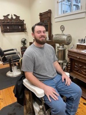 Guy In Grey Shirt After Haircut Side View — New Orleans, LA — Bad Habit Barber Shop