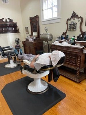Guy In Grey Shirt Towel Shave Back View — New Orleans, LA — Bad Habit Barber Shop