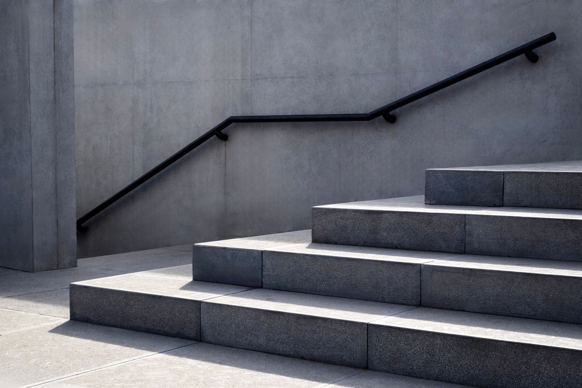 Construction site with circular foundation formwork, rebar, and workers.