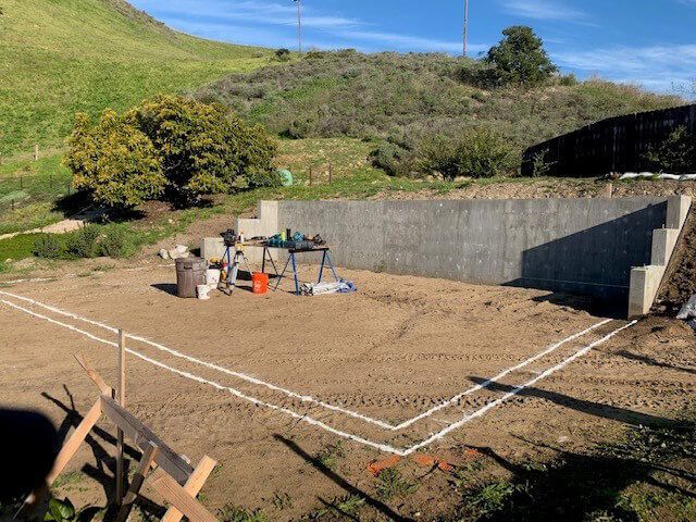 Construction site with white-lined foundation layout.