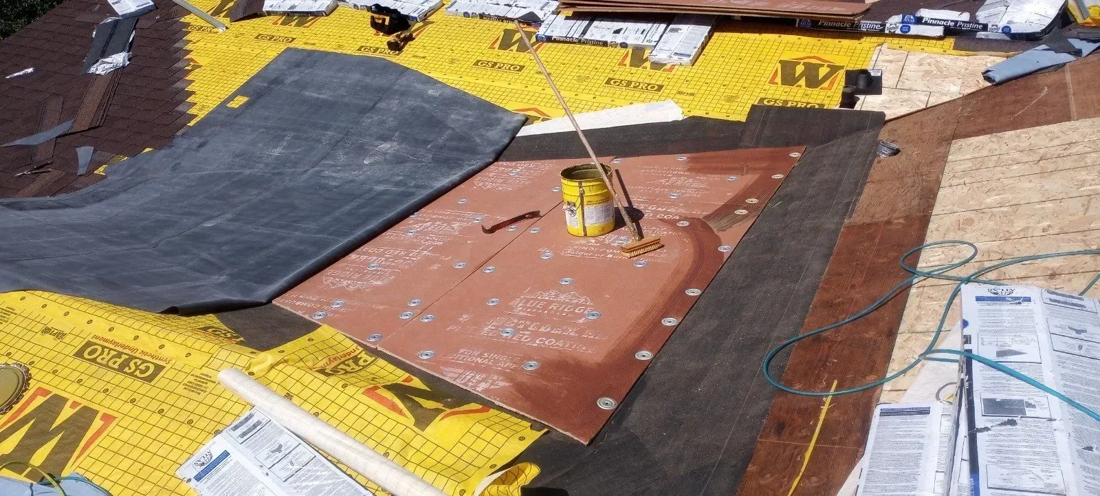 A roof is being built with a lot of papers on it