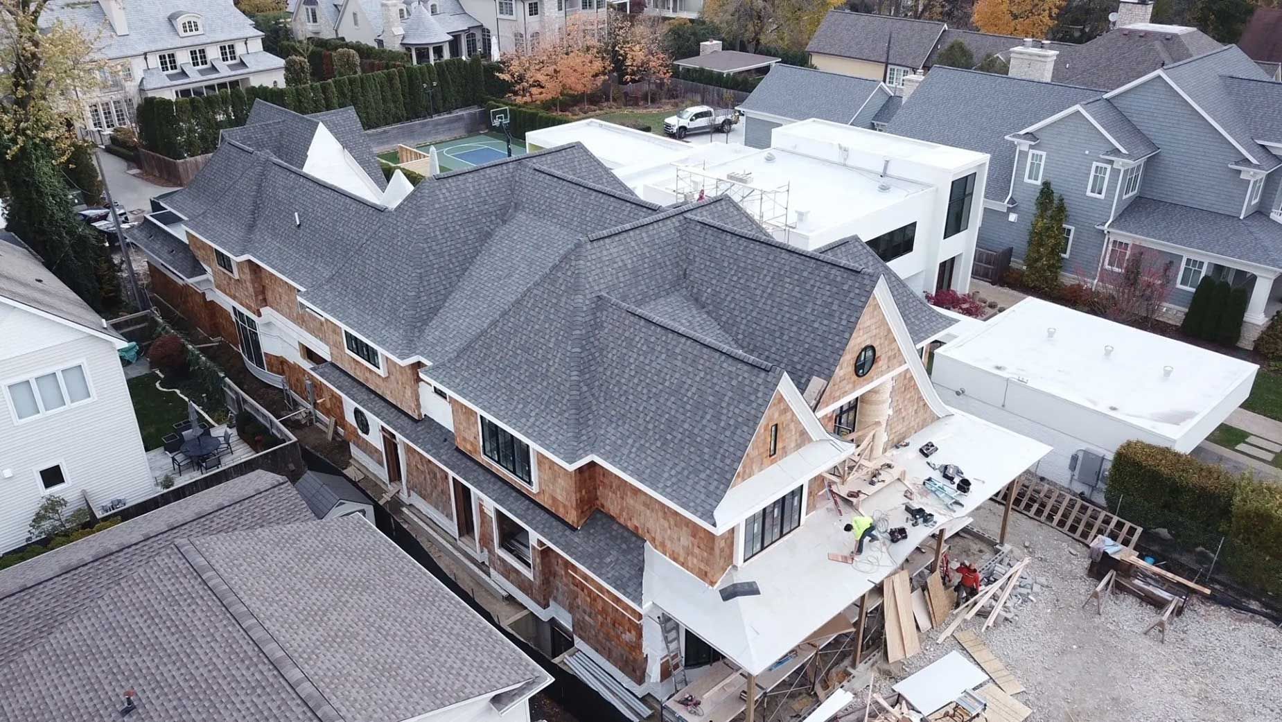 An aerial view of a house under construction in a residential area.