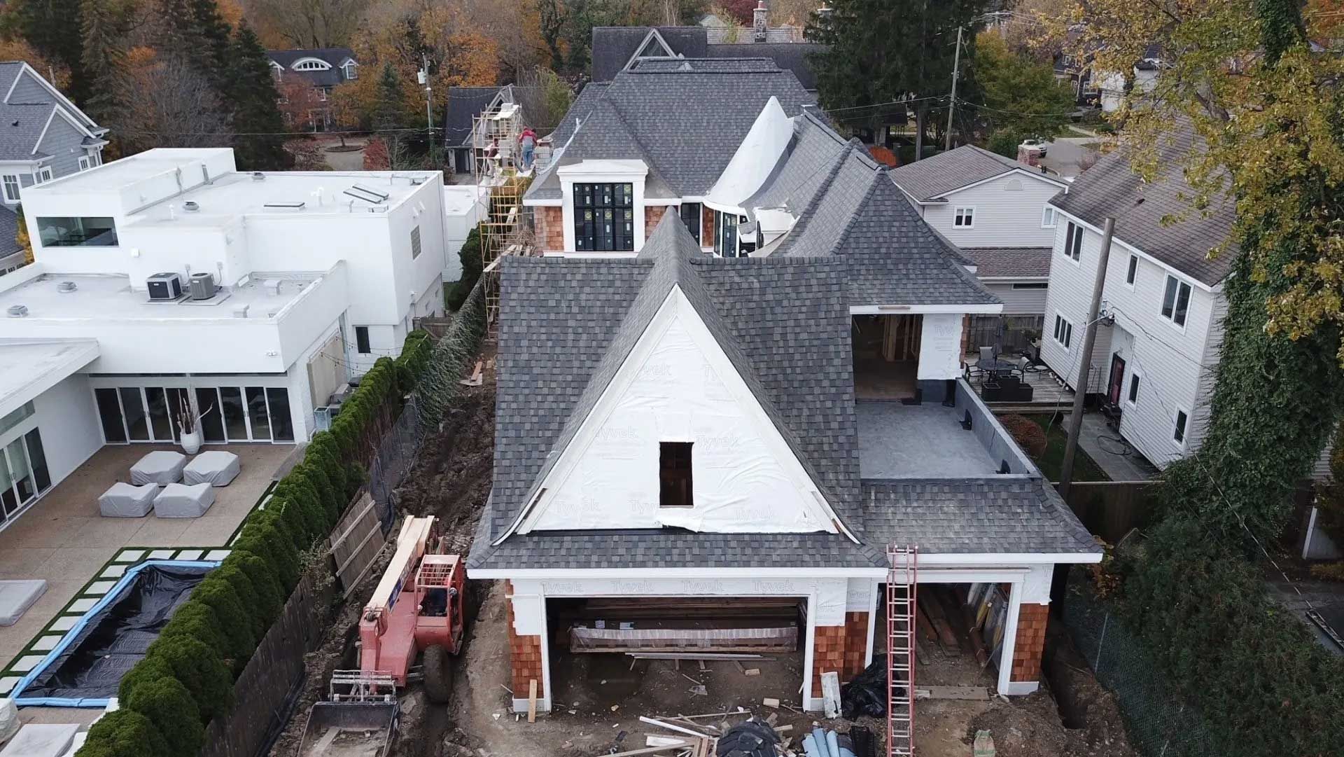 An aerial view of a house under construction in a residential area.