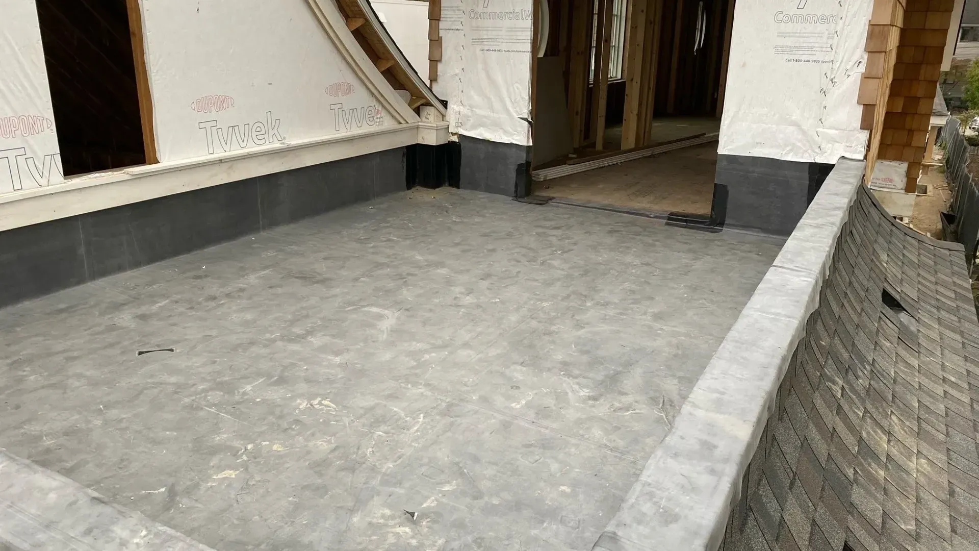 A large concrete area in front of a building under construction.