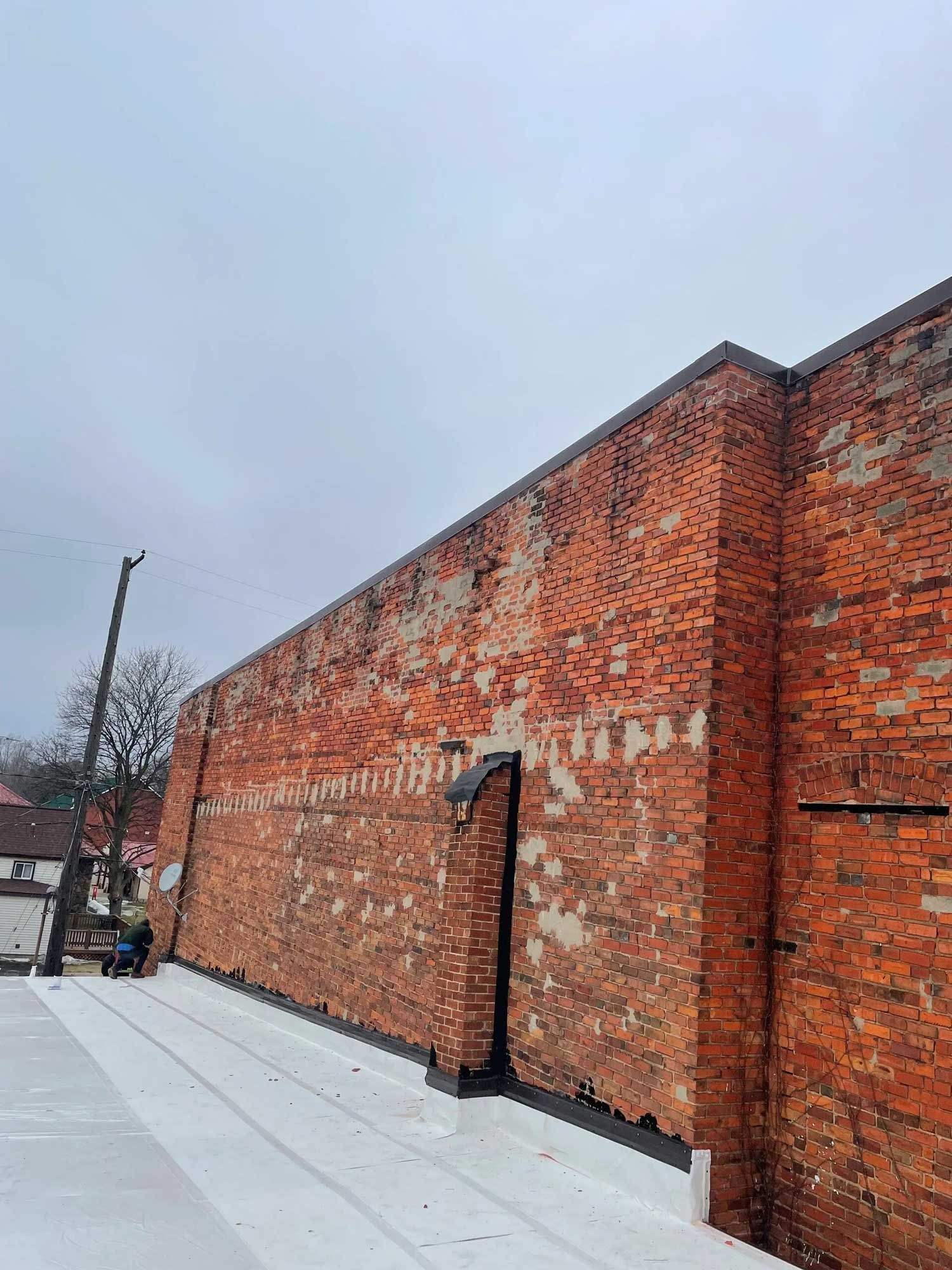 A large red brick building with a white roof.