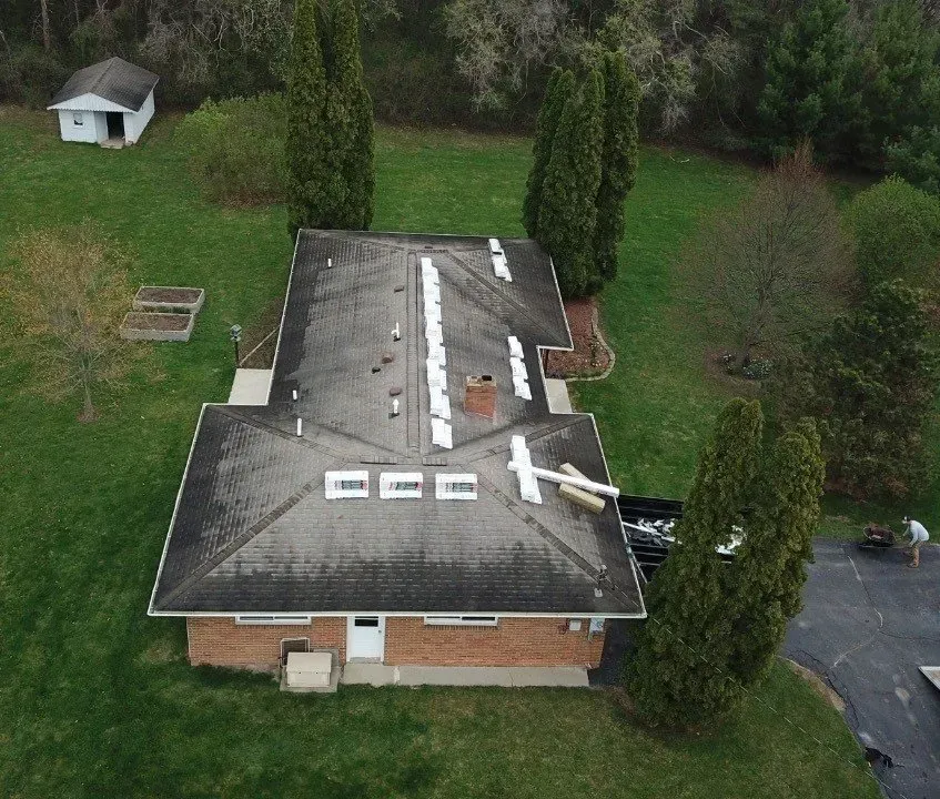 An aerial view of a house with a broken roof