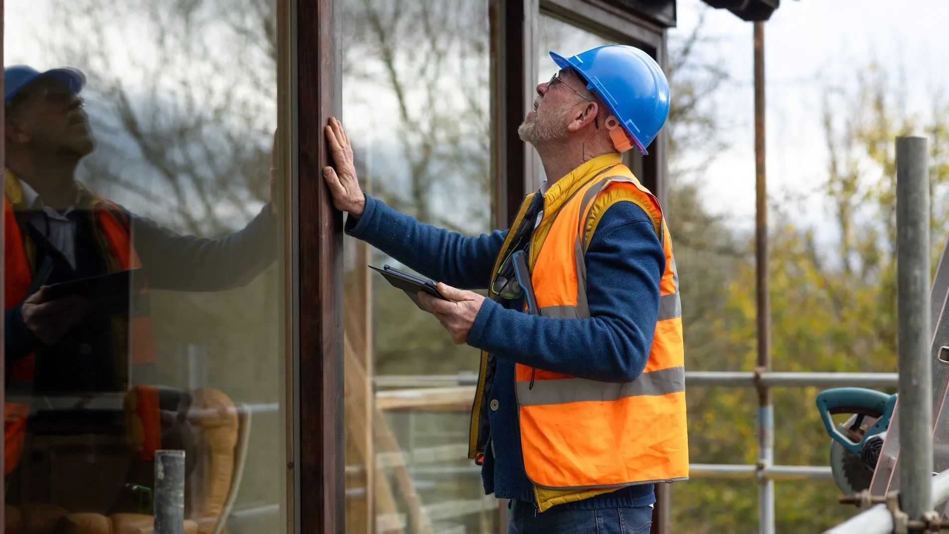 Surveyor inspecting windows as part of a Level 3 building survey