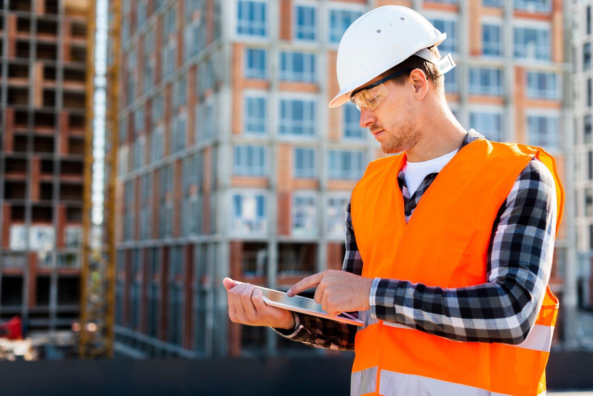 Building surveyor looking at a tablet
