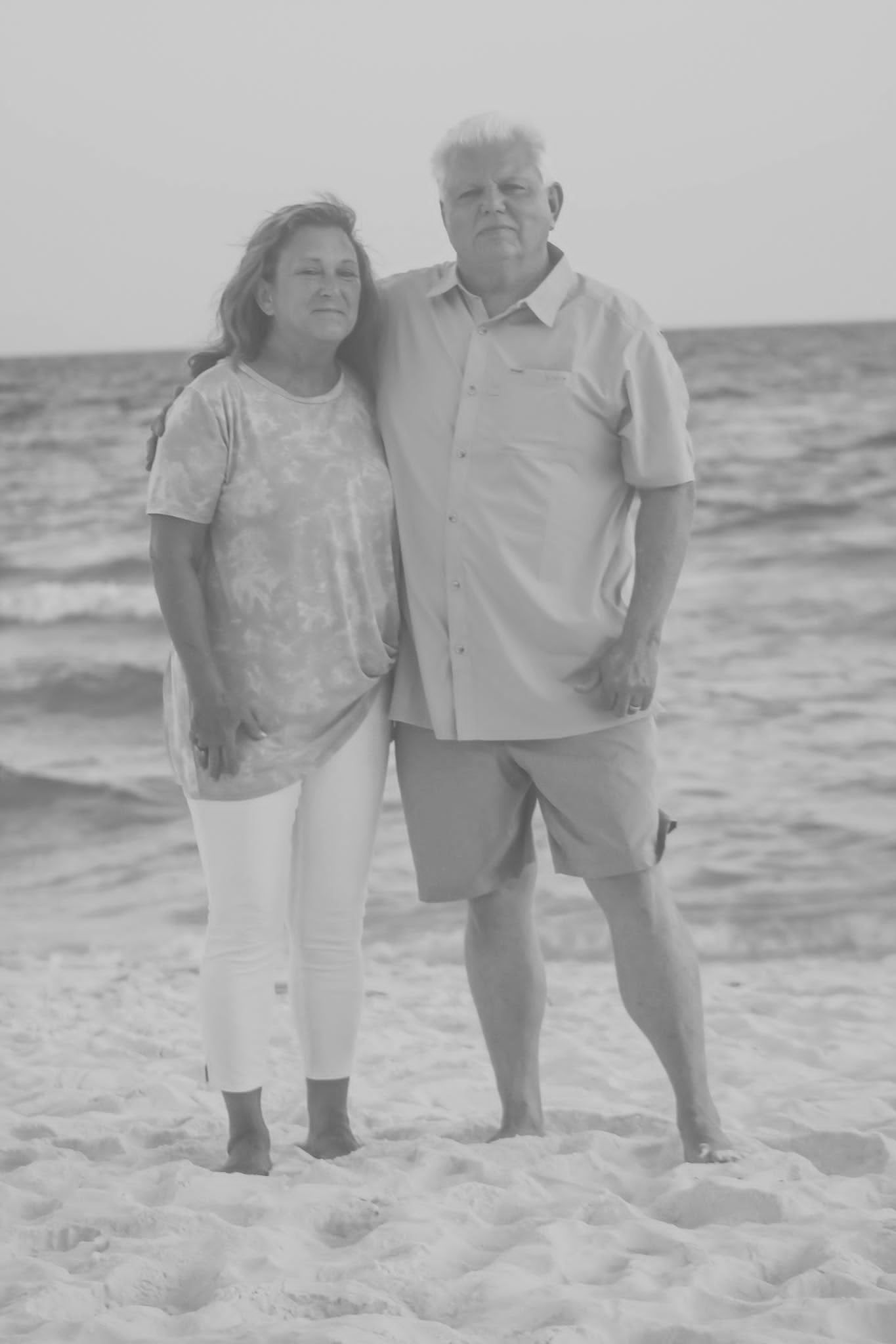 Couple posing together on the beach for an engagement photography session in Newnan, GA.