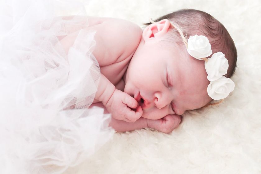 Sleeping newborn baby wrapped in a white blanket with a bow headband – Shine Again Photography newborn portraits in Newnan, GA