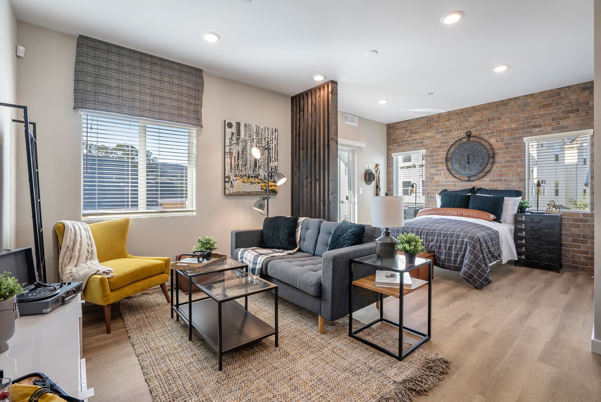 Studio apartment interior with living and sleeping areas, neutral colors, and modern furniture.