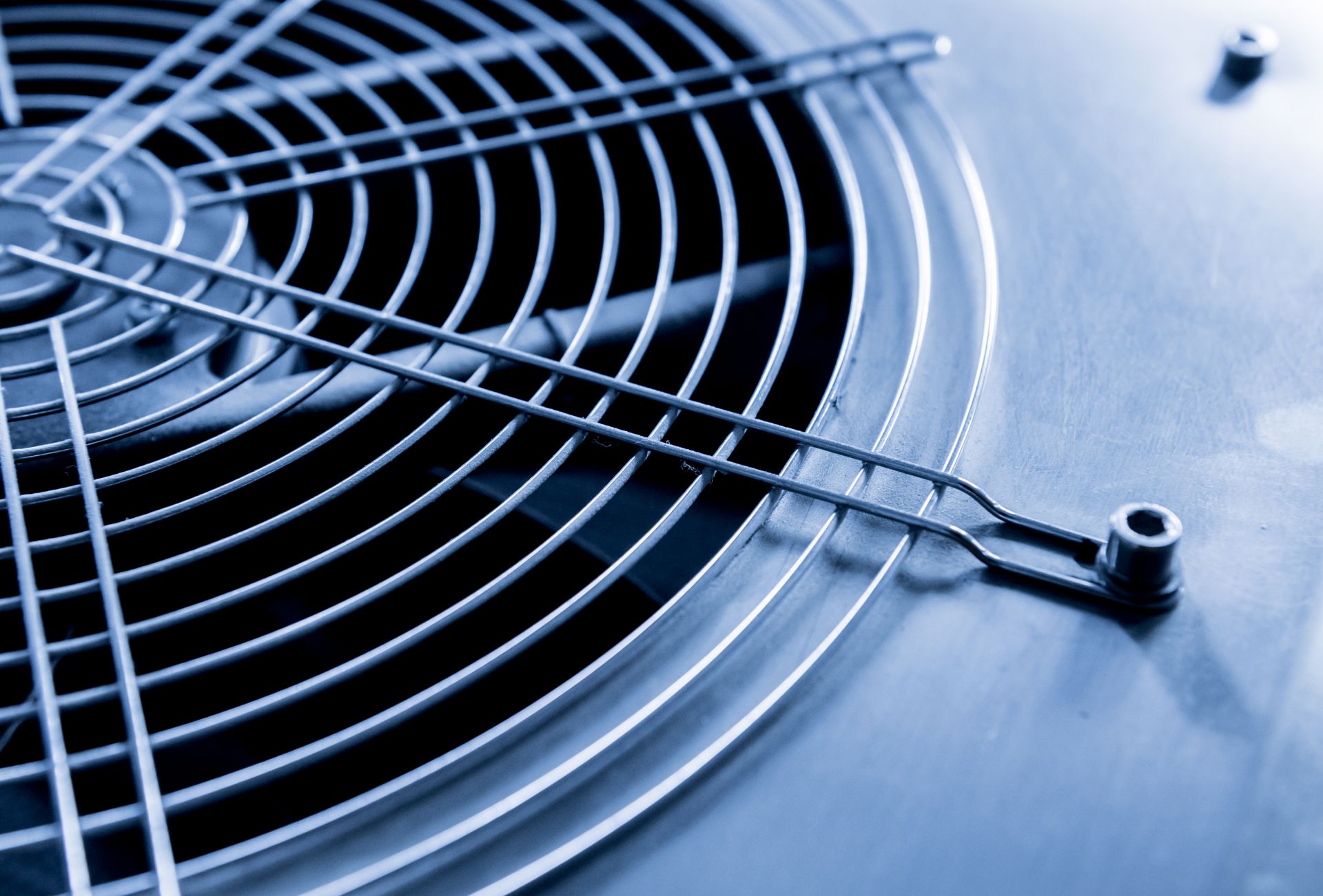 Close-up of a computer fan with a protective metal grill.