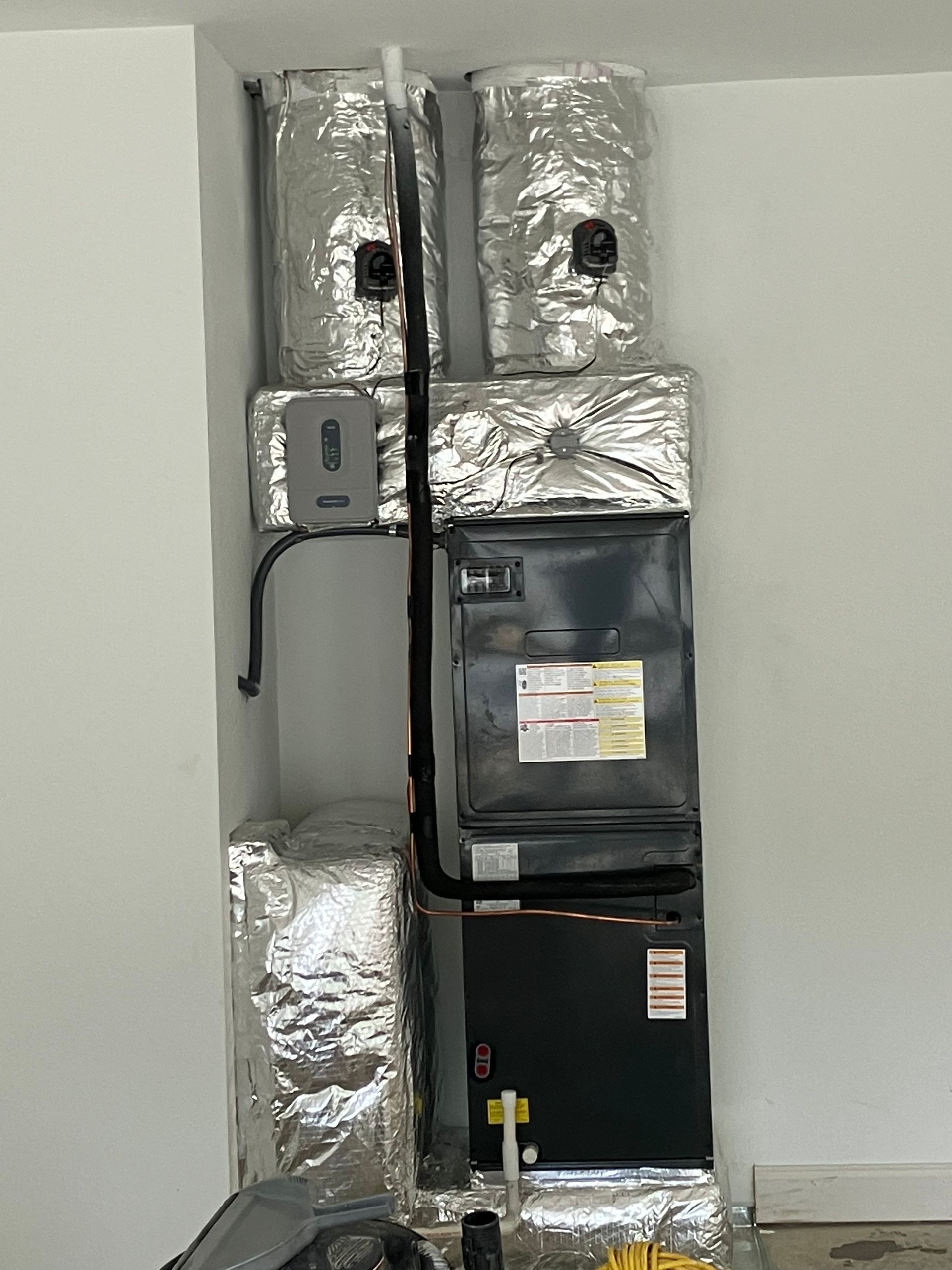 A room with a heater and a lot of insulation on the walls.