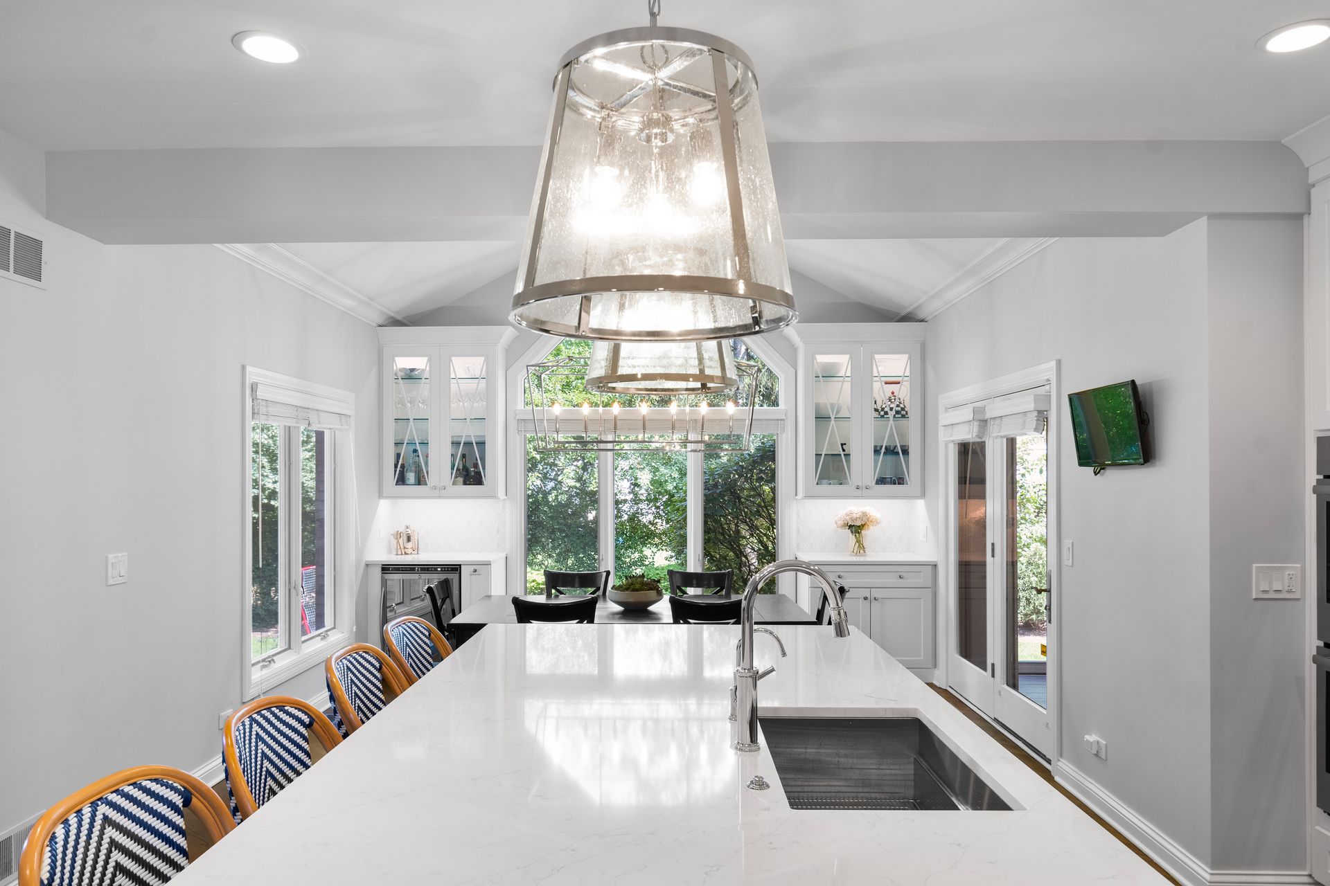 A kitchen with a large island and a sink.