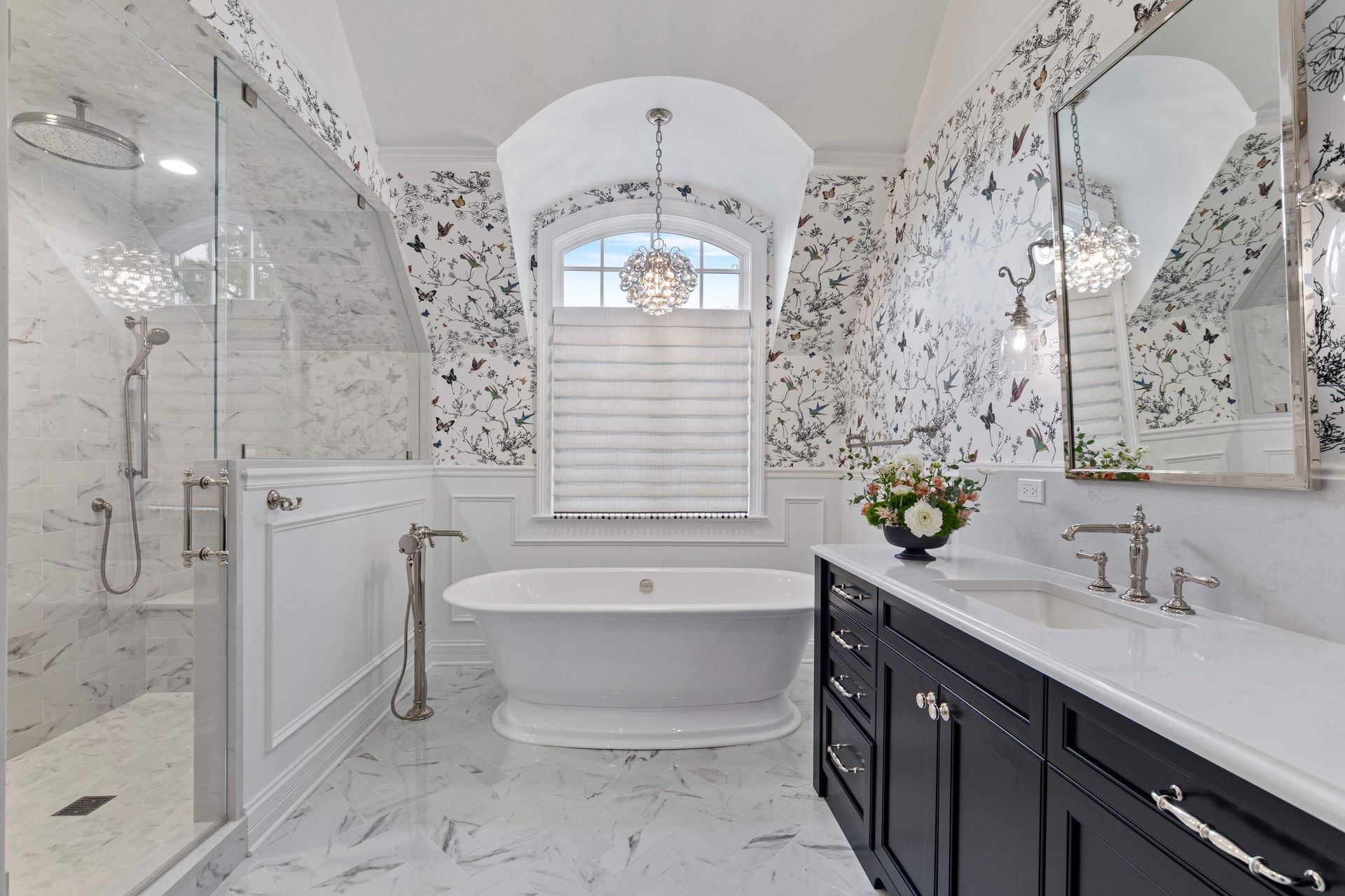 A bathroom with a bathtub , sink , and shower.