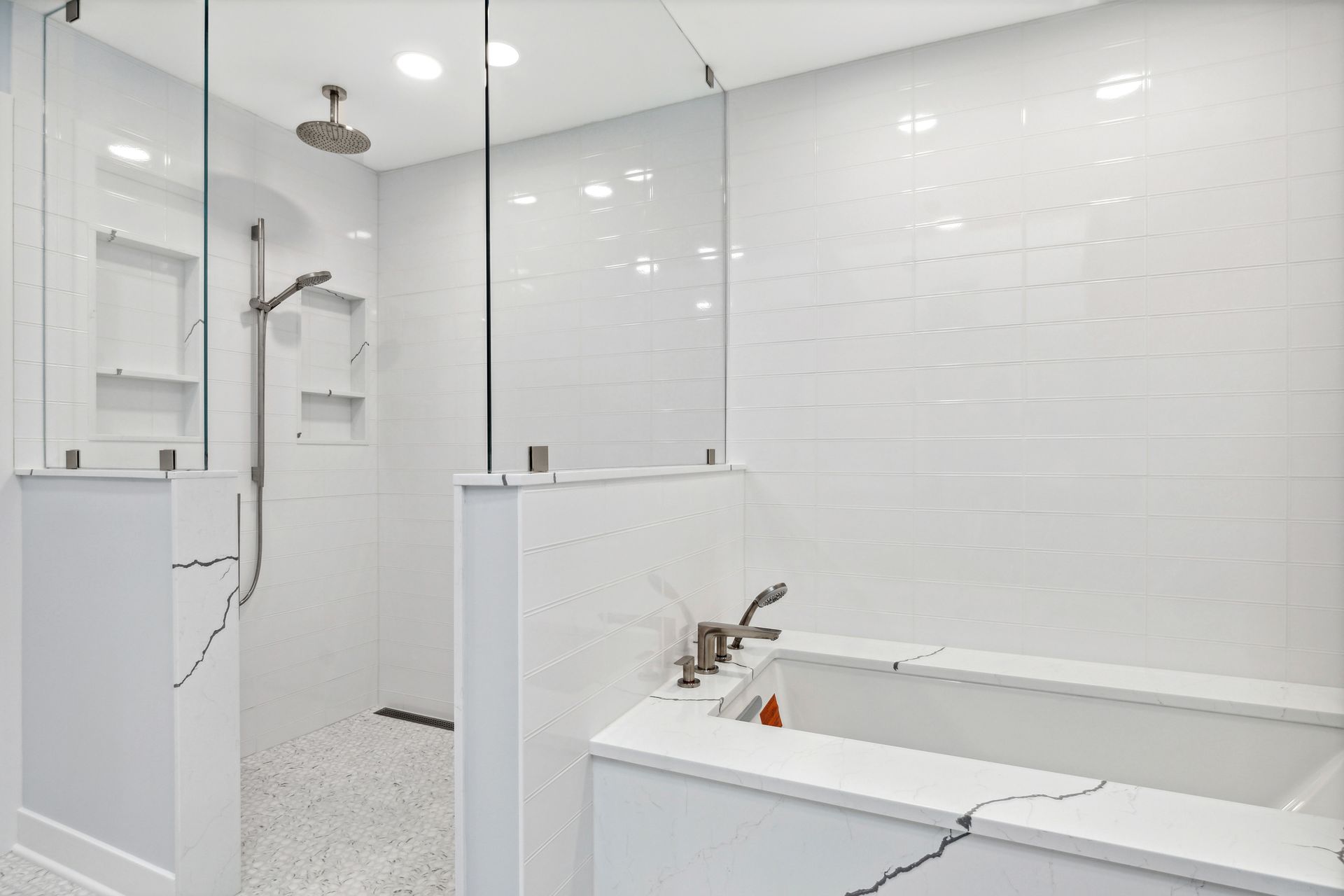 A bathroom with a bathtub , sink , and shower.