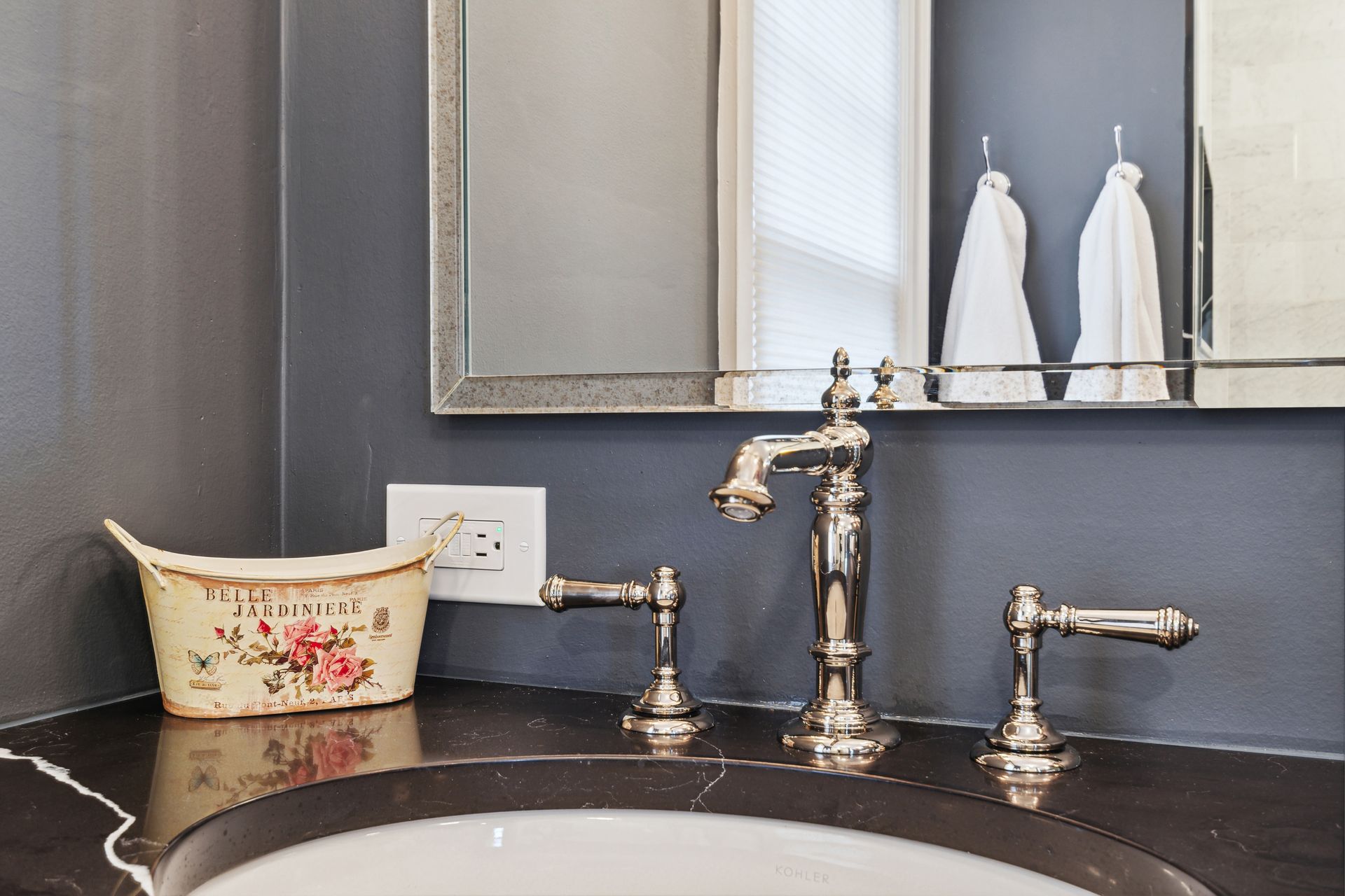 A bathroom sink with a mirror and a bowl on the counter