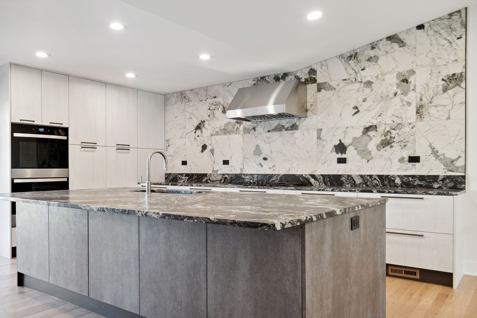 There is a large island in the middle of the kitchen.