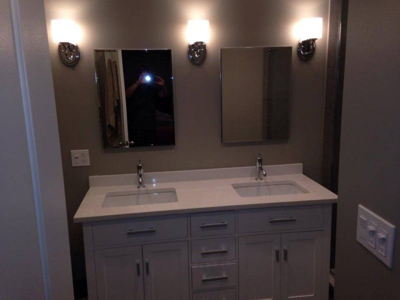 A bathroom with two sinks and two mirrors