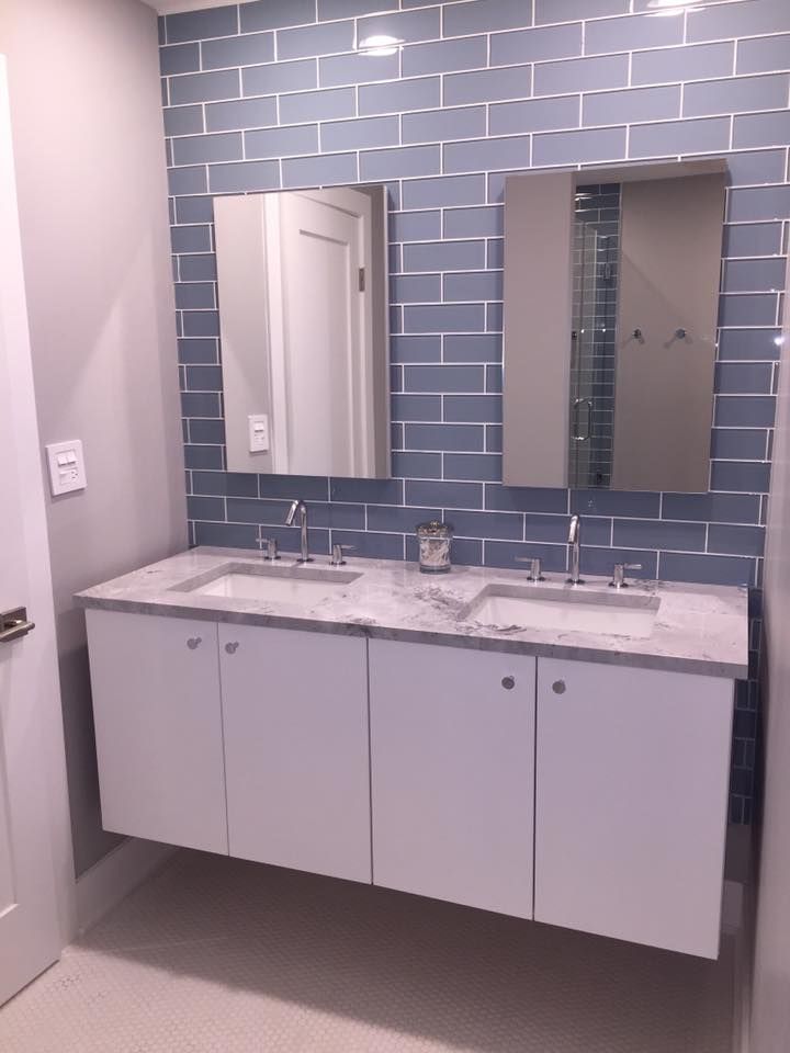 A bathroom with two sinks and a mirror