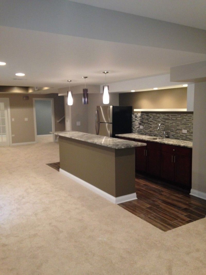 A kitchen with a large island and a refrigerator
