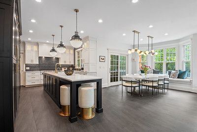 A kitchen and dining room with a large island in the middle of the room.