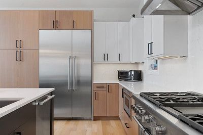 A kitchen with stainless steel appliances and wooden cabinets.